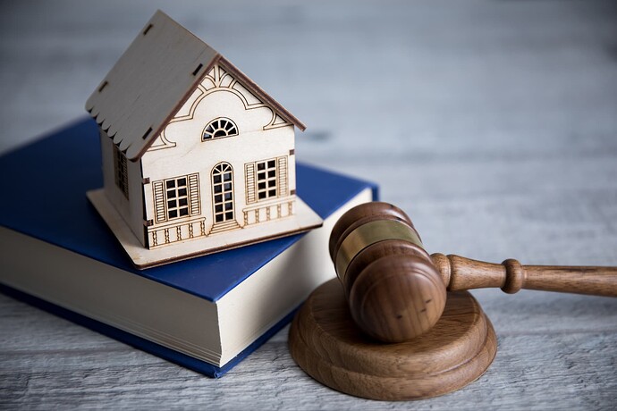 House on a book next to a gavel